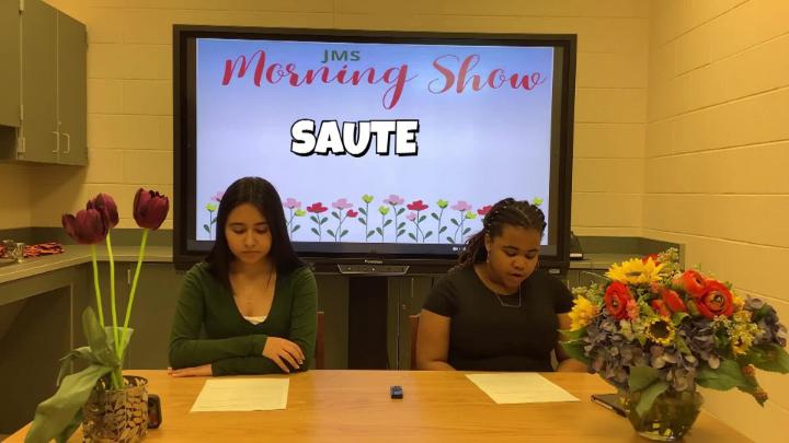 Two female Jamestown Middle School students deliver their school newscast