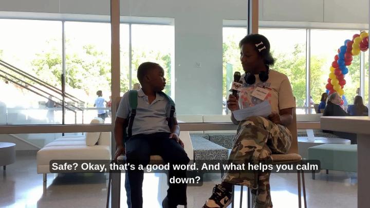 A female Northeast Middle School student interviews a male elementary age student