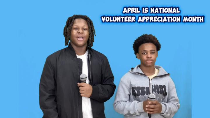 Two male Mendenhall Middle School students holding microphones as they deliver their morning news