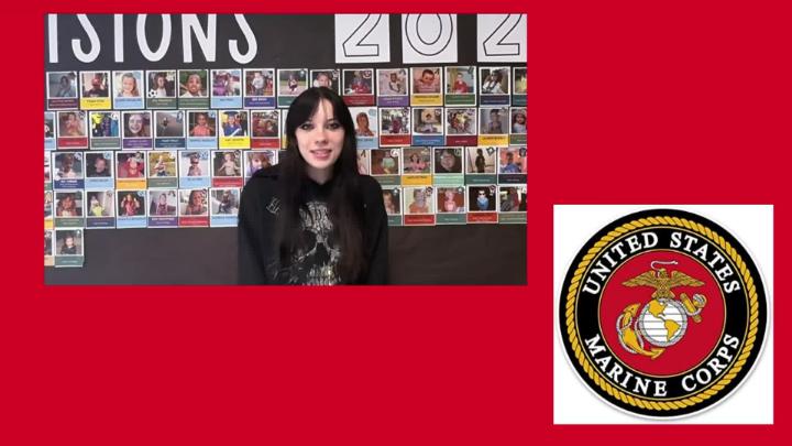 Northwest H.S. senior stands in front of Decision Day 2026 bulletin board