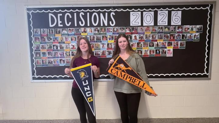 Northwest H.S. seniors stand in front of Decision Day 2026 bulletin board