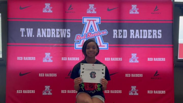 Andrews H.S. senior sits in front of a red background with Andews Red Raiders logo