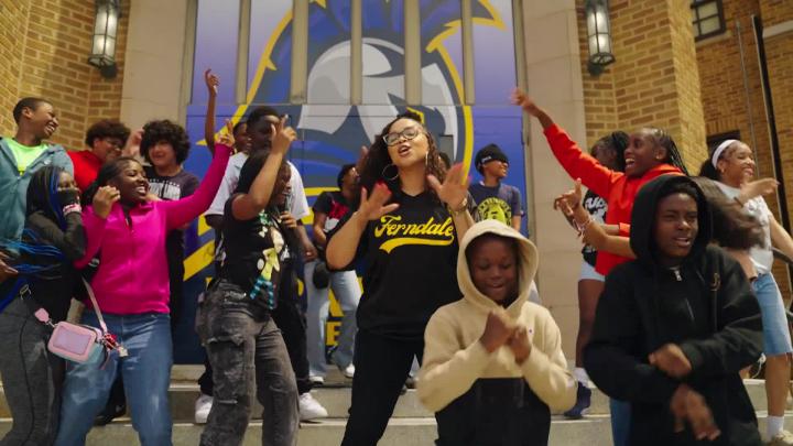 Ferndale Middle Principal Chelsea Smith with a group of her students on steps of school building